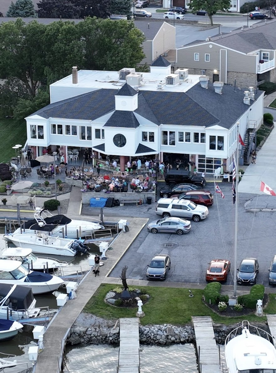 Aerial view of the Huron Yacht Club clubhouse, patio, and marina along the Huron River